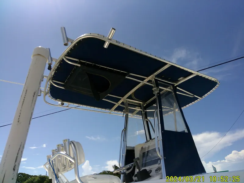 Slide: The Image of 2004 Contender 23 Open boat with T-top under clear blue sky. - 5