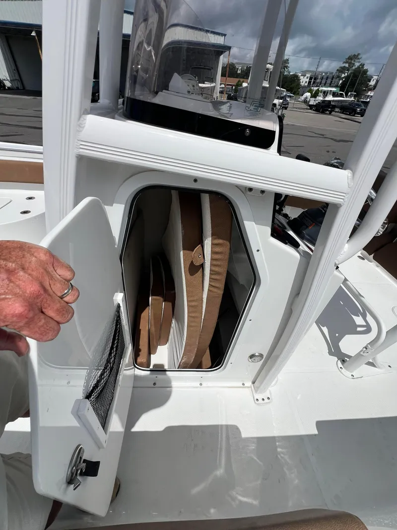 Slide: The Image of 2022 Sea Hunt Ultra 229 boat storage compartment with cushions inside. - 10
