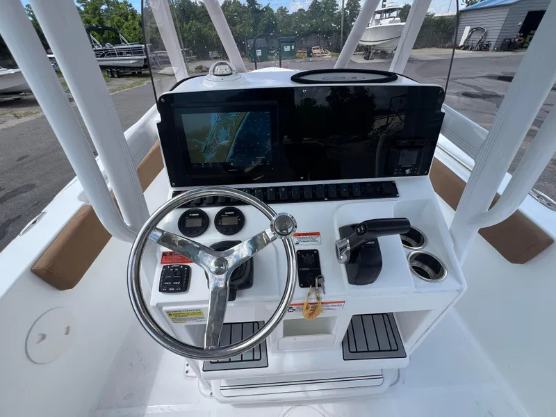 Slide: The Image of 2022 Sea Hunt Ultra 229 boat dashboard with steering wheel and navigation display. - 12
