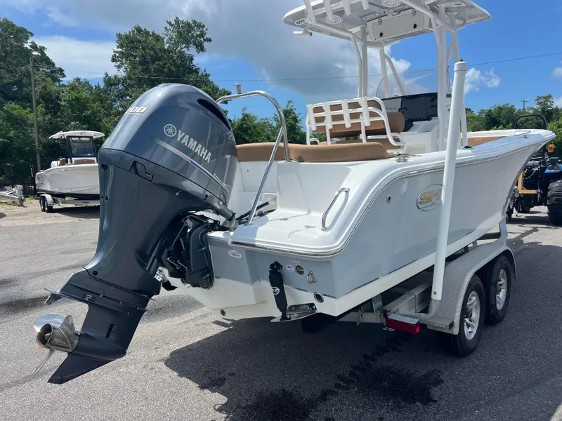 Slide: The Image of 2022 Sea Hunt Ultra 229 boat with Yamaha engine on trailer, parked outdoors. - 3