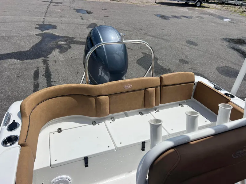 Slide: The Image of 2022 Sea Hunt Ultra 229 boat interior with tan seating and rod holders. - 5