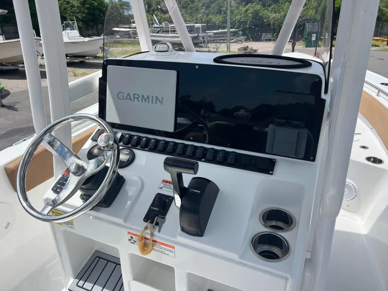 Slide: The Image of 2022 Sea Hunt Ultra 229 boat dashboard with Garmin navigation system and steering wheel. - 6