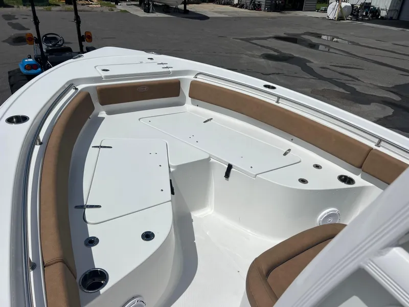 Slide: The Image of 2022 Sea Hunt Ultra 229 boat interior with cushioned seating and storage compartments. - 7