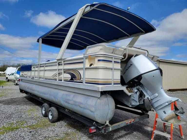 The Image of 1999 Crest 30 Savannah pontoon boat with Honda outboard motor on trailer. - 0