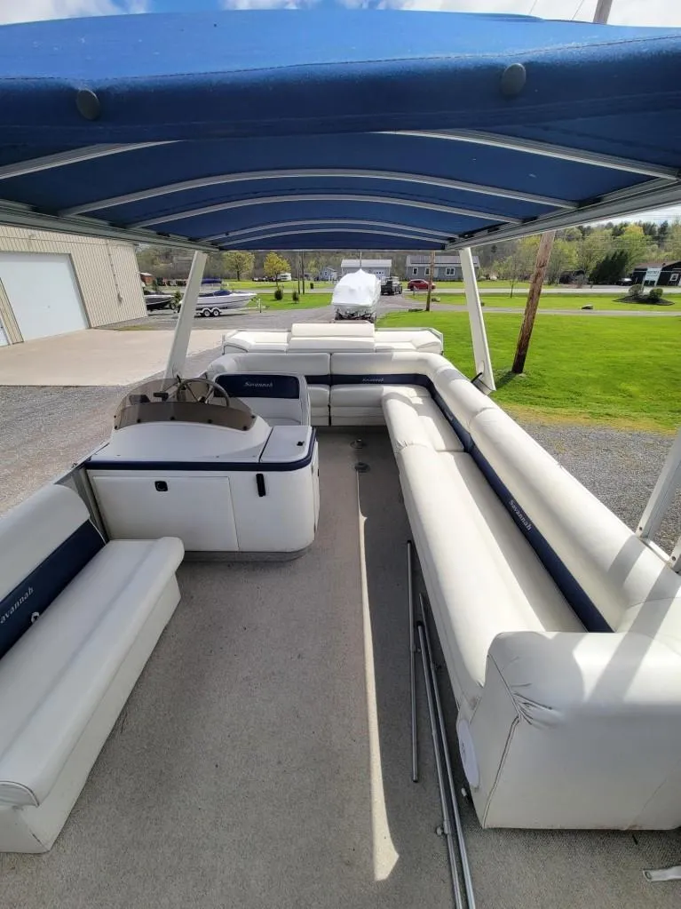 Slide: The Image of 1999 Crest 30 Savannah pontoon boat with blue canopy and spacious seating. - 3