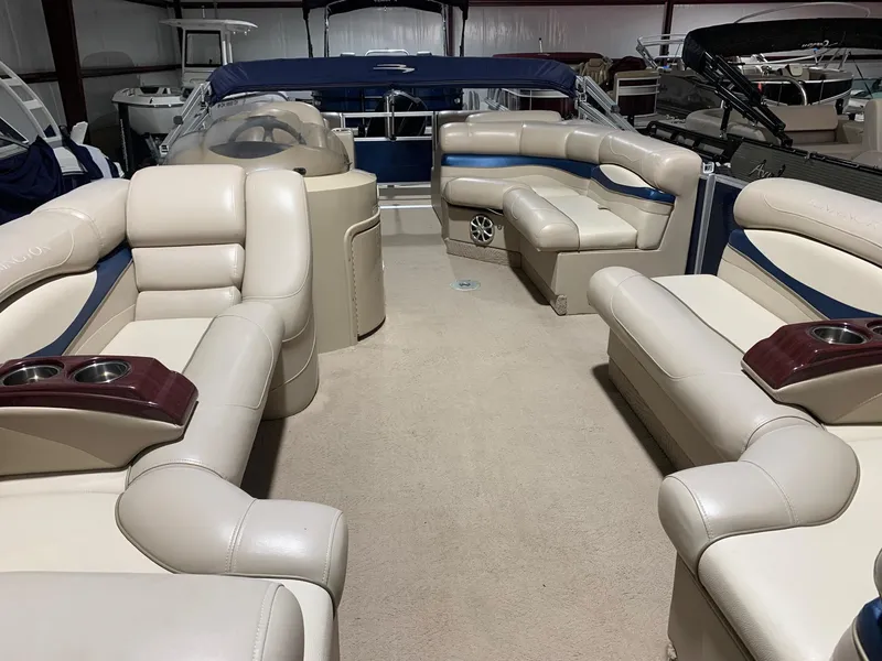 Slide: The Image of 2010 Bennington 2250RCW pontoon boat interior with beige seating and cup holders. - 12