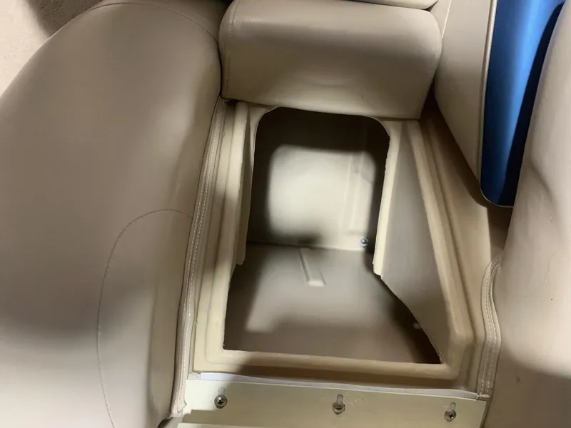 Slide: The Image of Open storage compartment in a 2010 Bennington 2250RCW boat with beige upholstery. - 15