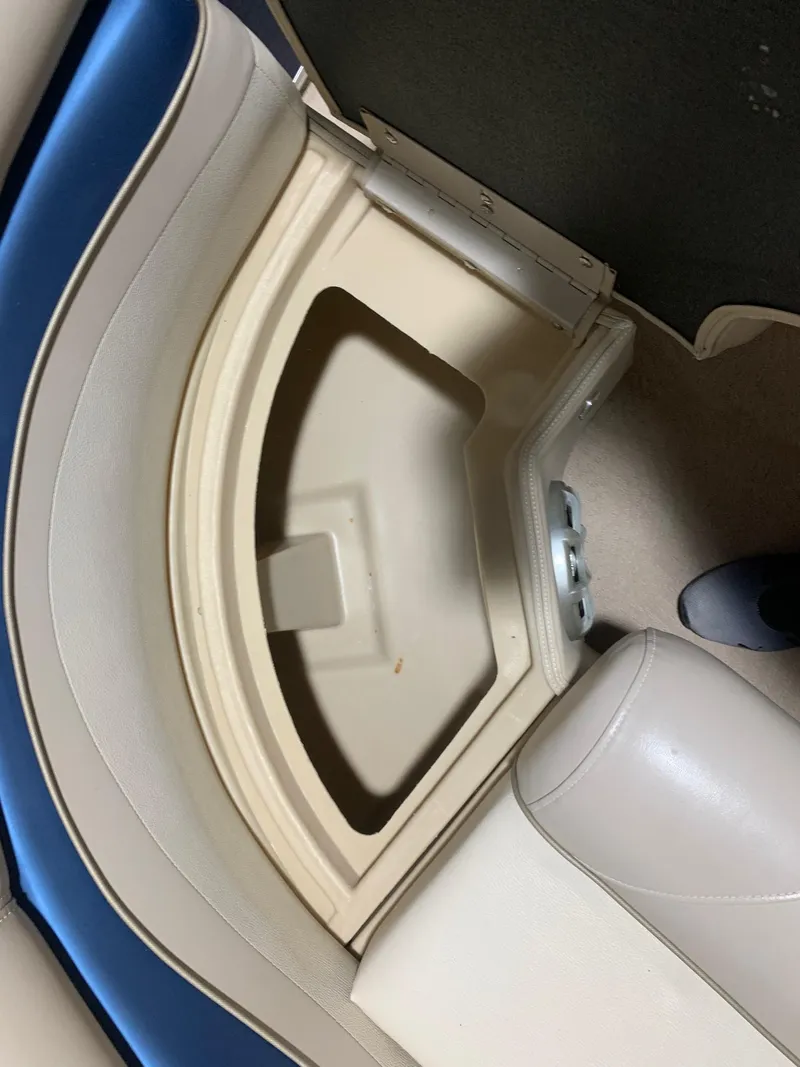 Slide: The Image of Storage compartment in a 2010 Bennington 2250RCW boat with beige and blue seating. - 20