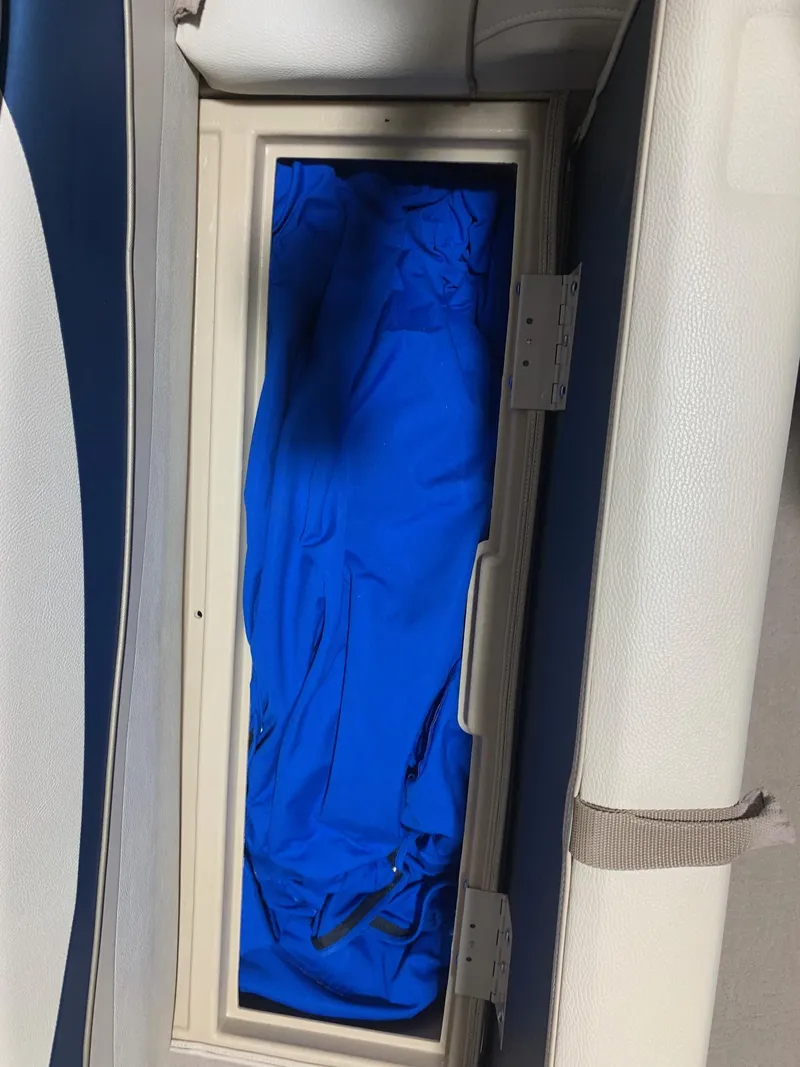 Slide: The Image of Storage compartment in a 2010 Bennington 2250RCW boat with blue fabric inside. - 21