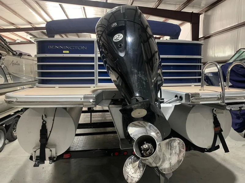 Slide: The Image of 2010 Bennington 2250RCW pontoon boat with outboard motor in a storage facility. - 3