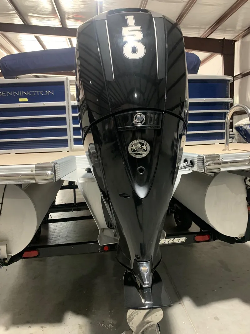 Slide: The Image of 2010 Bennington 2250RCW boat with a 150 horsepower Mercury outboard motor in a storage facility. - 6
