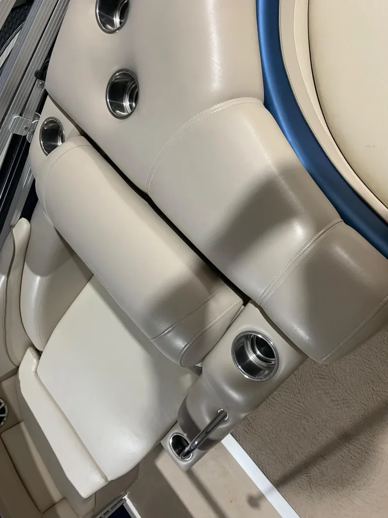 Slide: The Image of Luxurious seating on a 2010 Bennington 2250RCW boat with cup holders and beige upholstery. - 7