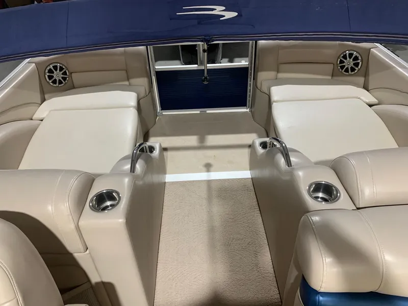 Slide: The Image of Interior of 2010 Bennington 2250RCW boat with beige seating and cup holders. - 8
