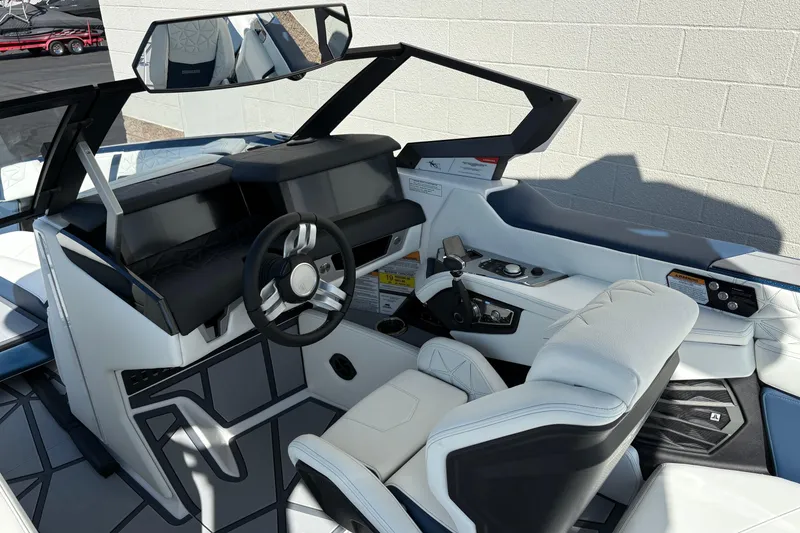 Slide: The Image of 2026 Nautique Super Air Nautique G25 Paragon cockpit with modern steering and controls. - 11