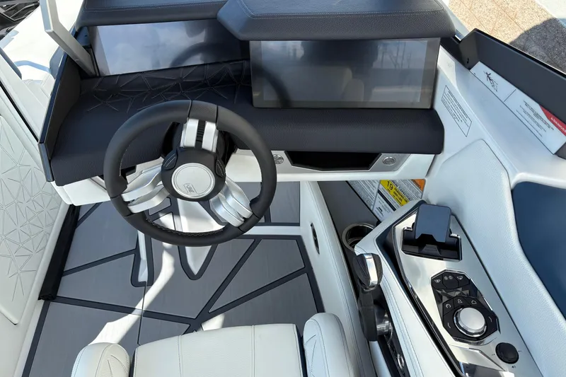 Slide: The Image of 2026 Nautique Super Air Nautique G25 Paragon cockpit with modern steering and controls. - 12