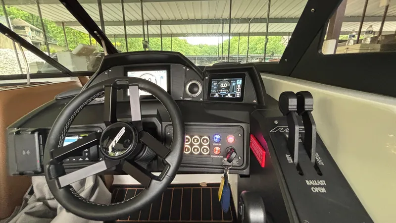 Slide: The Image of Interior dashboard of 2025 MB B52 23 Alpha boat with steering wheel and controls. - 11