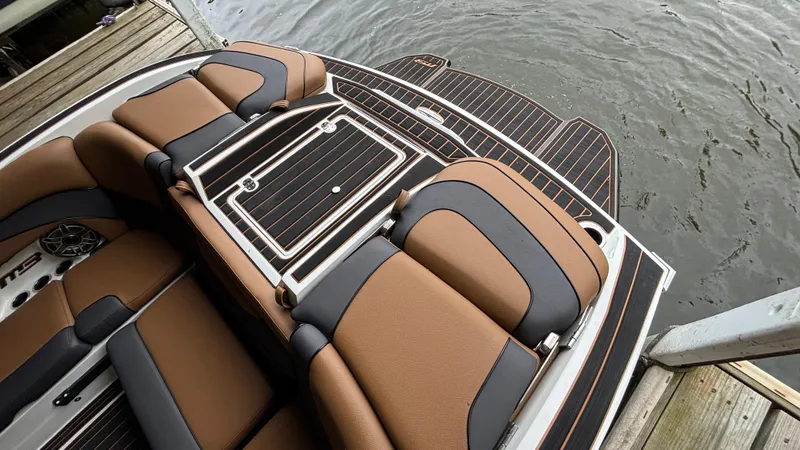 Slide: The Image of Luxury seating on 2025 MB B52 23 Alpha boat, docked by water. - 9