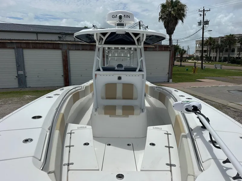 Slide: The Image of 2023 Cape Horn 32xs boat with Garmin equipment, docked near storage units. - 11