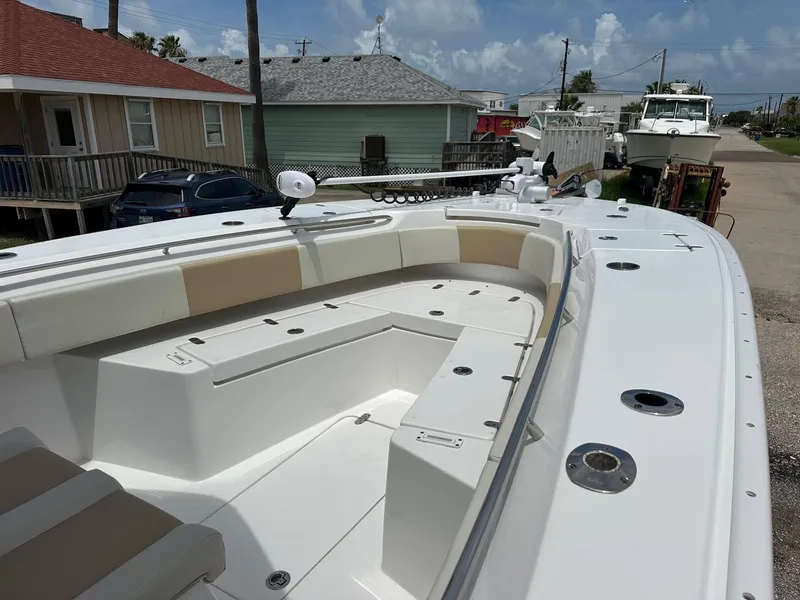 Slide: The Image of 2023 Cape Horn 32xs boat with spacious seating and modern design in a coastal setting. - 9