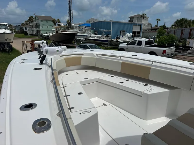 Slide: The Image of 2023 Cape Horn 32xs boat with spacious seating, docked in a marina under a cloudy sky. - 10