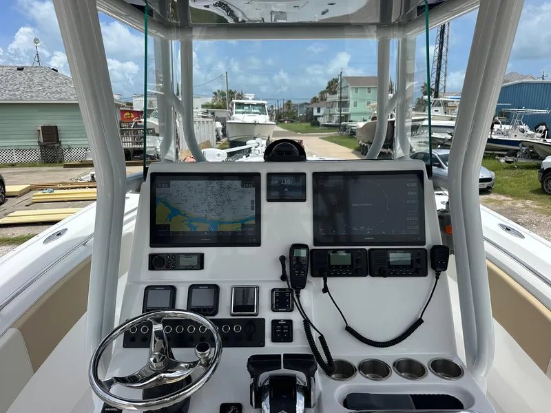 Slide: The Image of 2023 Cape Horn 32xs boat dashboard with navigation screens and controls. - 3