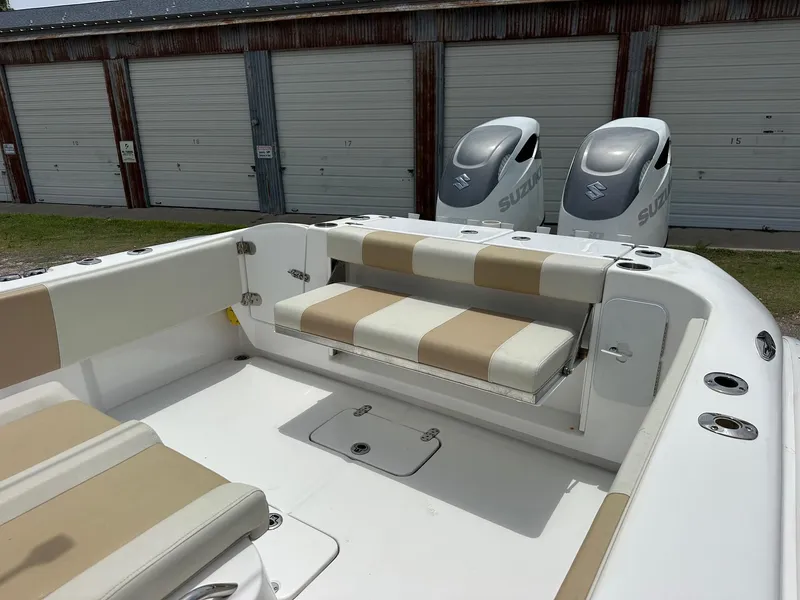Slide: The Image of 2023 Cape Horn 32xs boat interior with beige seating and dual Suzuki outboard motors. - 8