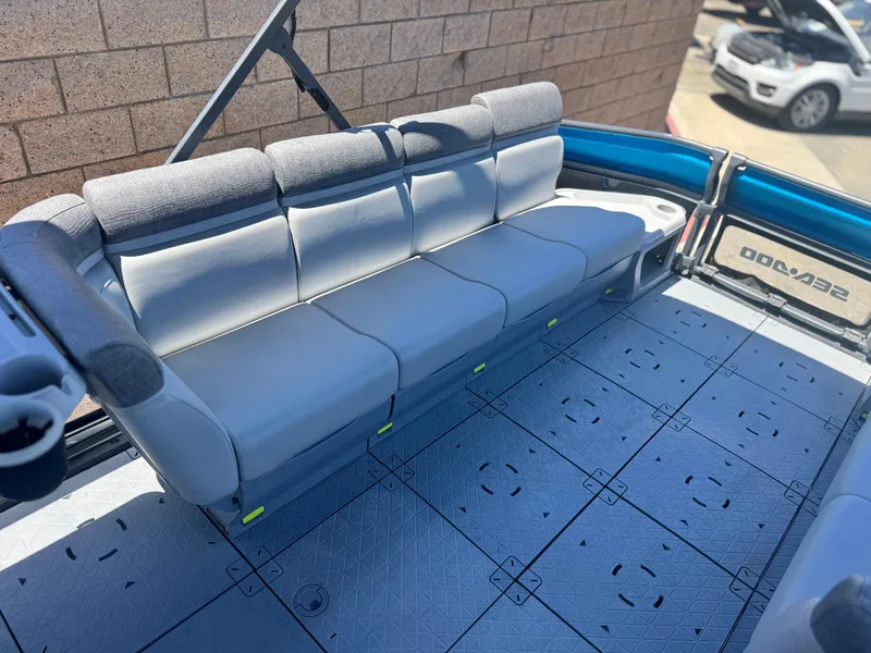 Slide: The Image of 2023 Sea-Doo Switch Cruise 21 interior with gray seating and modular flooring. - 10