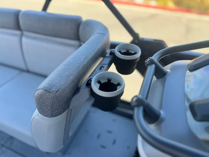 Slide: The Image of 2023 Sea-Doo Switch Cruise 21 interior with cup holders and seating. - 13