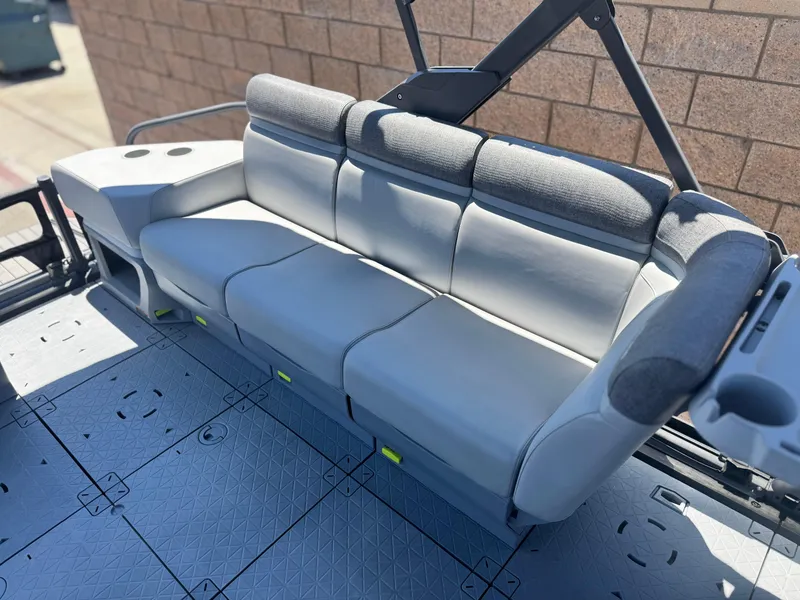 Slide: The Image of 2023 Sea-Doo Switch Cruise 21 boat seating with gray upholstery and cup holders. - 17