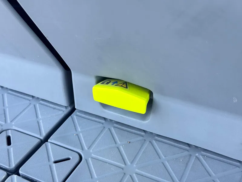 Slide: The Image of Yellow safety latch on 2023 Sea-Doo Switch Cruise 21 boat floor. - 19
