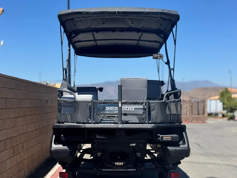 Slide: The Image of 2023 Sea-Doo Switch Cruise 21 pontoon boat, rear view, parked outdoors. - 5