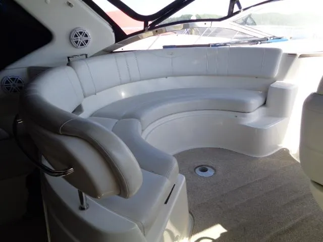 Slide: The Image of Luxurious seating area on a 2003 Regal Commodore 3860 yacht, featuring plush white upholstery. - 13