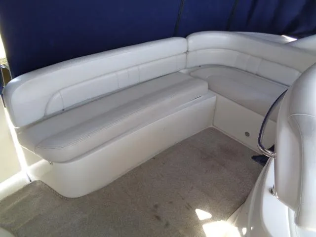 Slide: The Image of 2003 Regal Commodore 3860 boat interior with white cushioned seating and blue backdrop. - 16