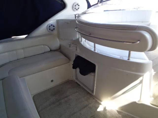 Slide: The Image of 2003 Regal Commodore 3860 yacht interior with white seating and built-in speakers. - 17