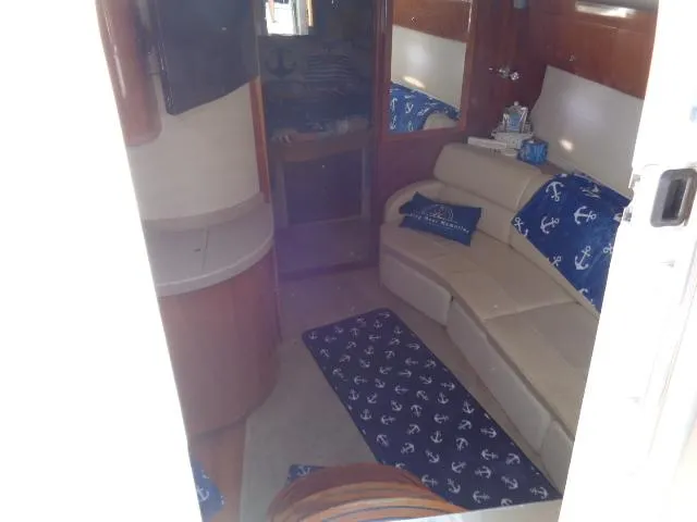 Slide: The Image of Interior of 2003 Regal Commodore 3860 yacht with anchor-themed decor and beige seating. - 18