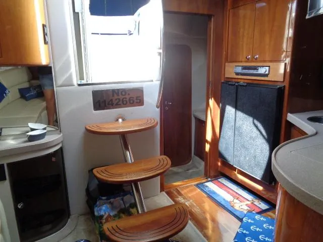 Slide: The Image of 2003 Regal Commodore 3860 yacht interior with wooden steps and modern kitchen amenities. - 21