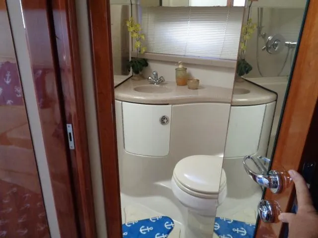 Slide: The Image of Bathroom interior of 2003 Regal Commodore 3860 yacht with modern fixtures and decor. - 28
