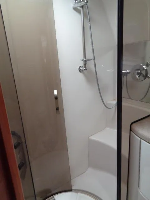 Slide: The Image of Shower area in 2003 Regal Commodore 3860 yacht, featuring modern fixtures and glass door. - 29