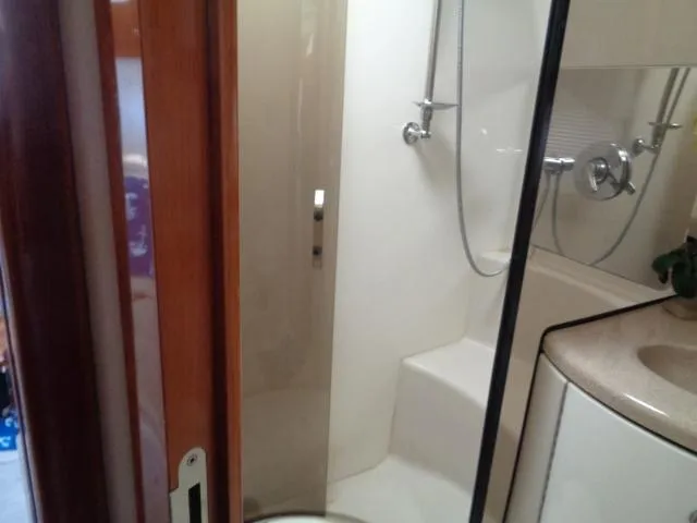 Slide: The Image of Bathroom interior of 2003 Regal Commodore 3860 yacht, featuring shower and sink. - 30