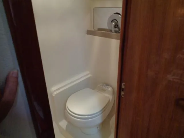 Slide: The Image of Compact bathroom in 2003 Regal Commodore 3860 yacht with toilet and wooden door. - 33