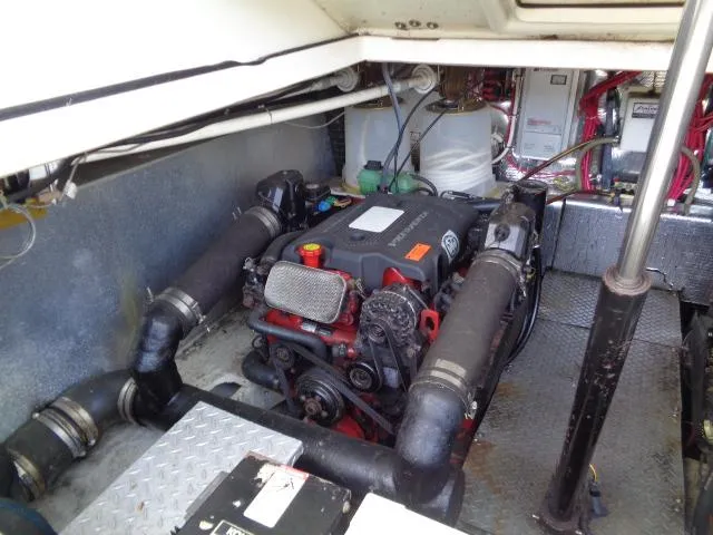 Slide: The Image of Engine room of 2003 Regal Commodore 3860 boat, showcasing mechanical components and piping. - 38