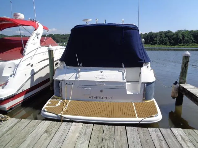 Slide: The Image of 2003 Regal Commodore 3860 yacht docked at a marina, covered with a navy blue tarp. - 4