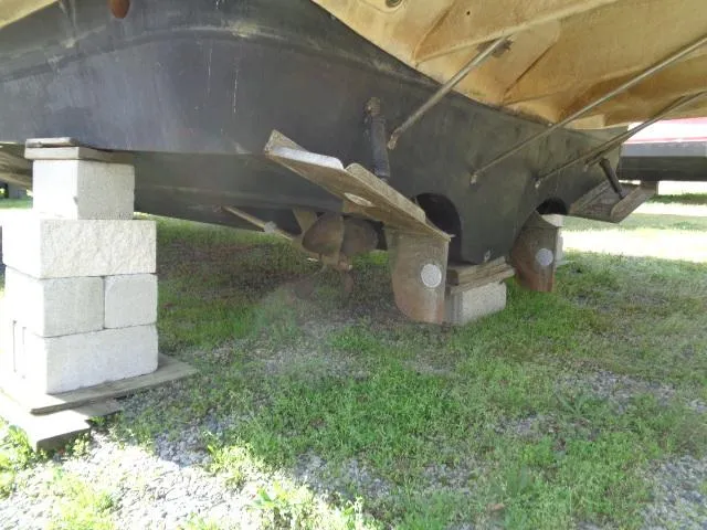 Slide: The Image of 2003 Regal Commodore 3860 boat hull supported by cinder blocks on grass. - 45