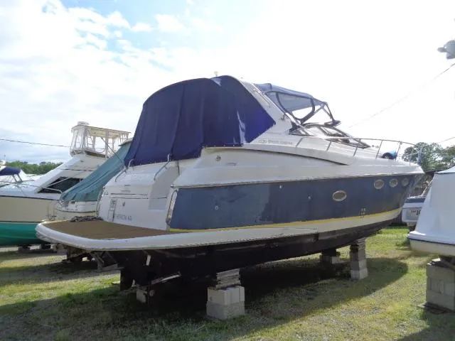 Slide: The Image of 2003 Regal Commodore 3860 yacht on blocks, covered, in a boatyard. - 6