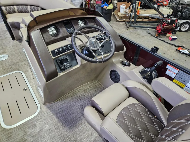 Slide: The Image of 2022 Bennington LX 23 Quad Bench boat interior with steering wheel and control panel. - 3