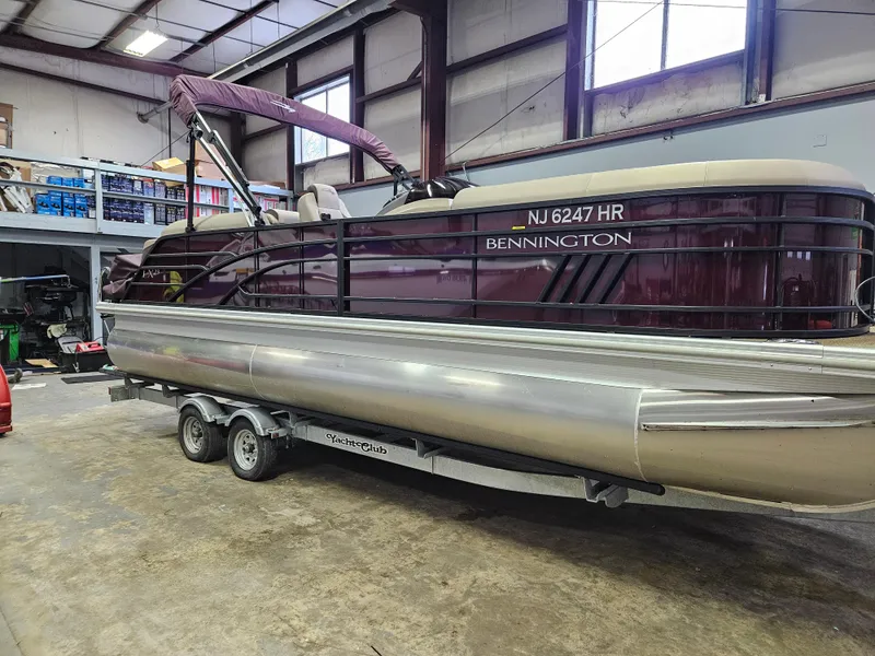 Slide: The Image of 2022 Bennington LX 23 Quad Bench pontoon boat on trailer in warehouse. - 7