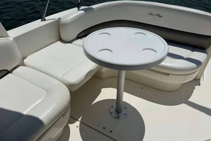 Slide: The Image of Interior seating area of a 2006 Sea Ray 260 Sundancer boat with a round table. - 10