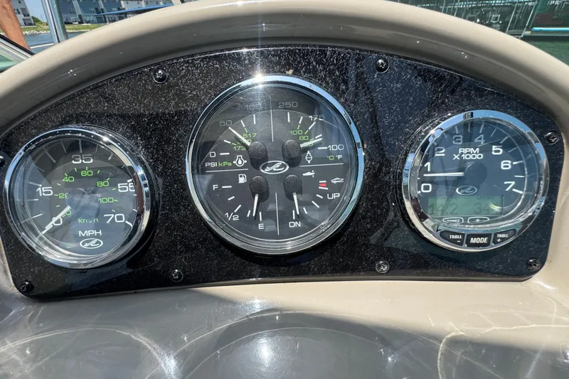 Slide: The Image of Dashboard of a 2006 Sea Ray 260 Sundancer boat with speedometer and gauges. - 13