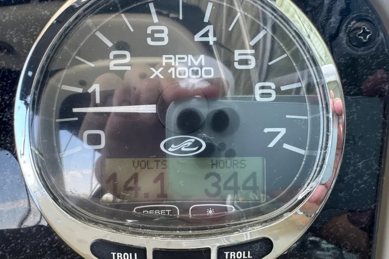 Slide: The Image of Close-up of a 2006 Sea Ray 260 Sundancer tachometer showing 344 hours and 14.1 volts. - 14