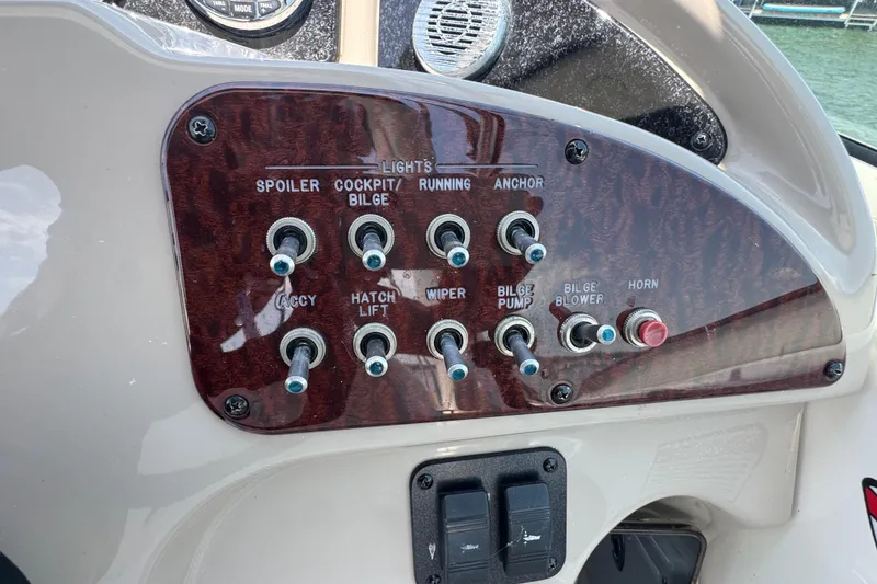 Slide: The Image of Control panel of a 2006 Sea Ray 260 Sundancer boat with labeled switches. - 17
